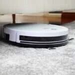 Robot vacuum cleaning hardwood floors in a home