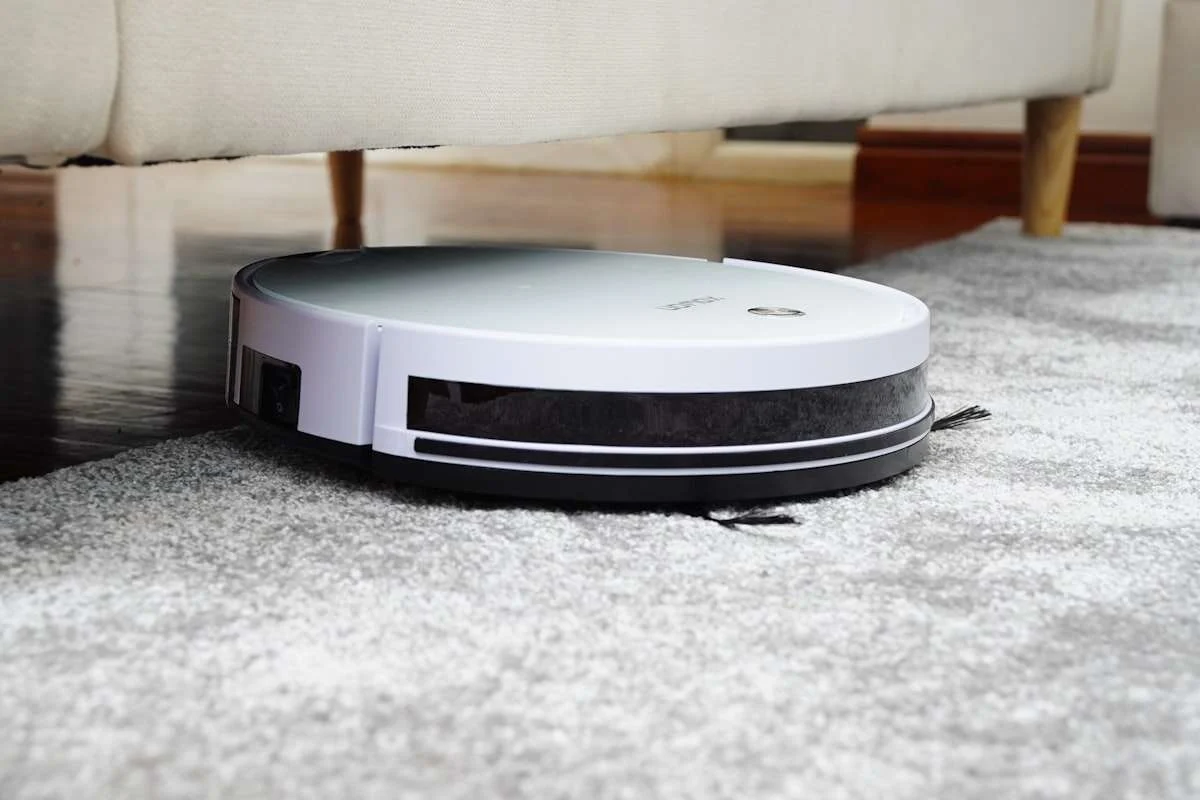 Robot vacuum cleaning hardwood floors in a home